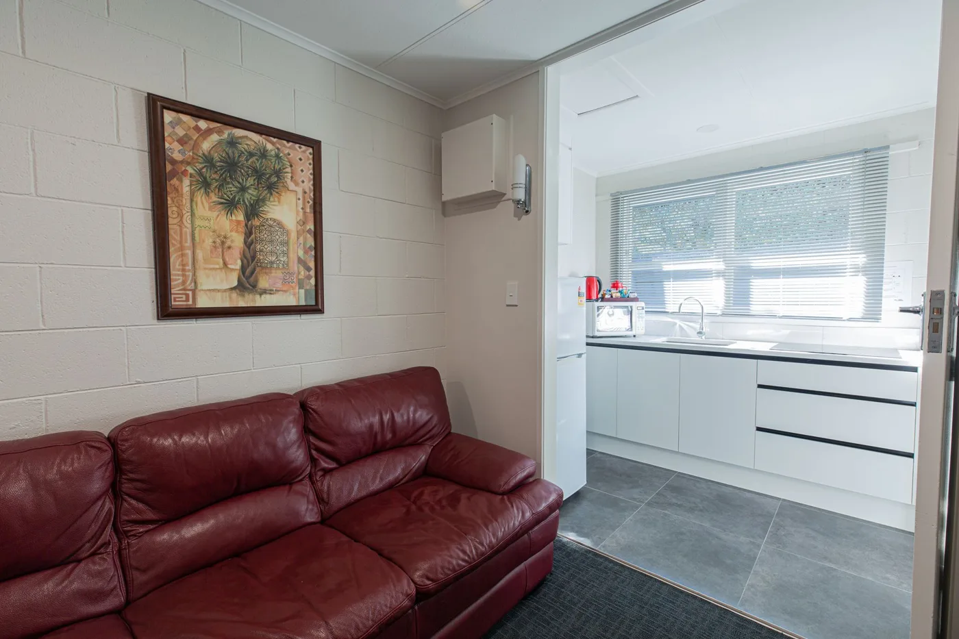 Lounge and kitchen in the Playroom Apartment at Lake Breeze Motel